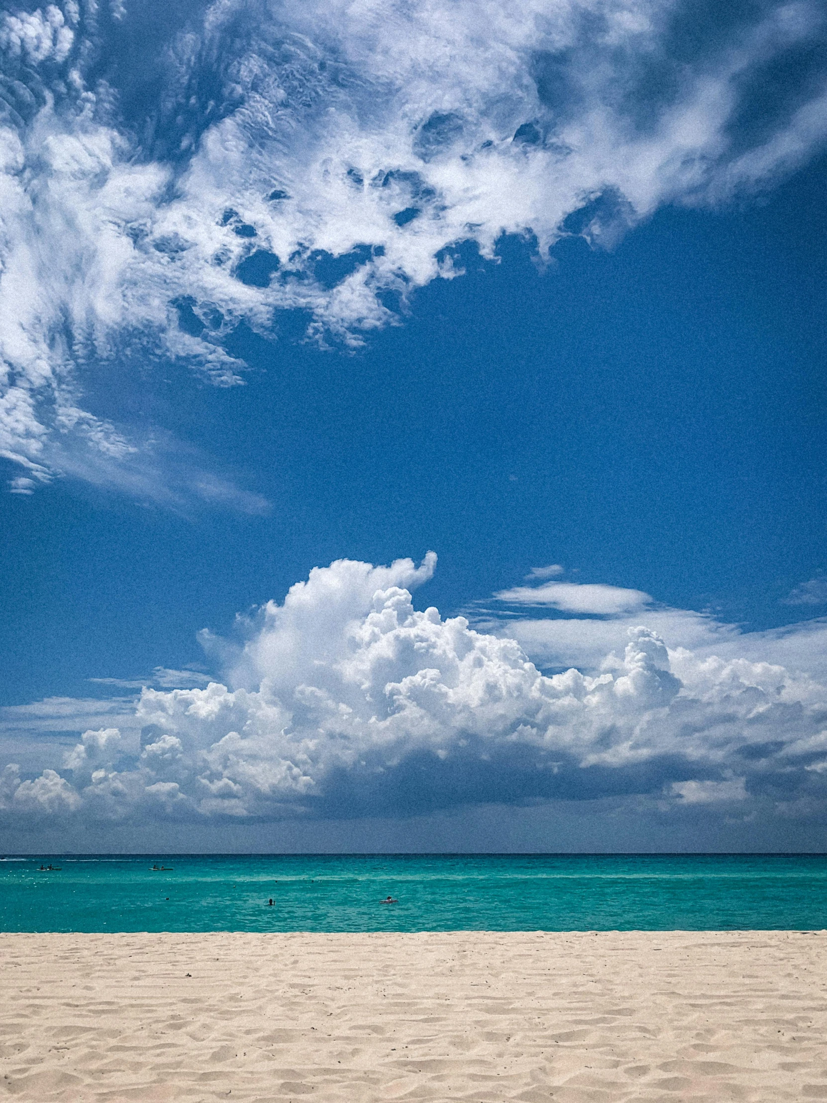 a beach with people out in the water