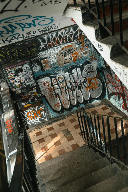 the stairs in a stairwell covered in graffiti