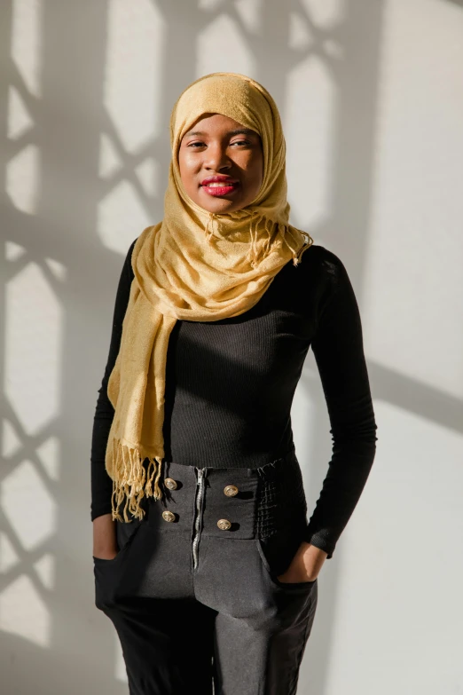 a woman with a black top and a tan scarf