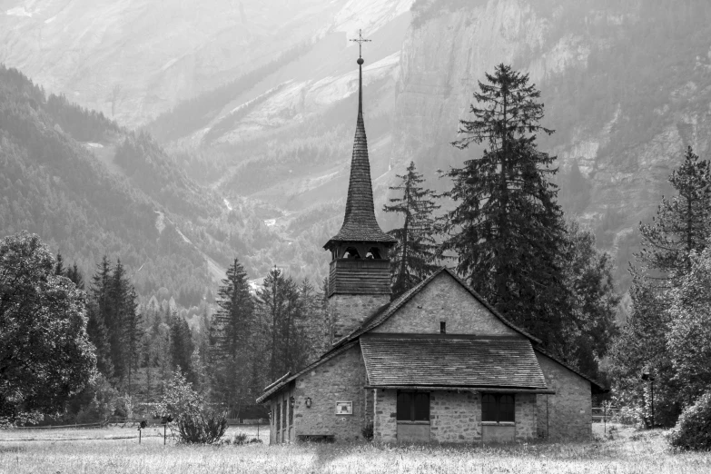 the small church has steeple with a clock on it