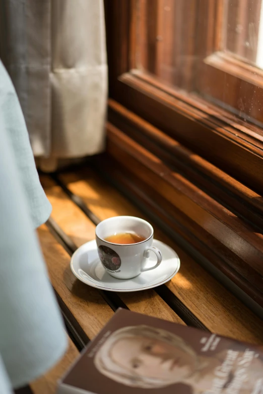 a coffee cup and saucer sitting on top of a wooden table