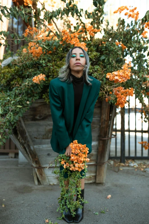 a woman posing in front of some pretty flowers