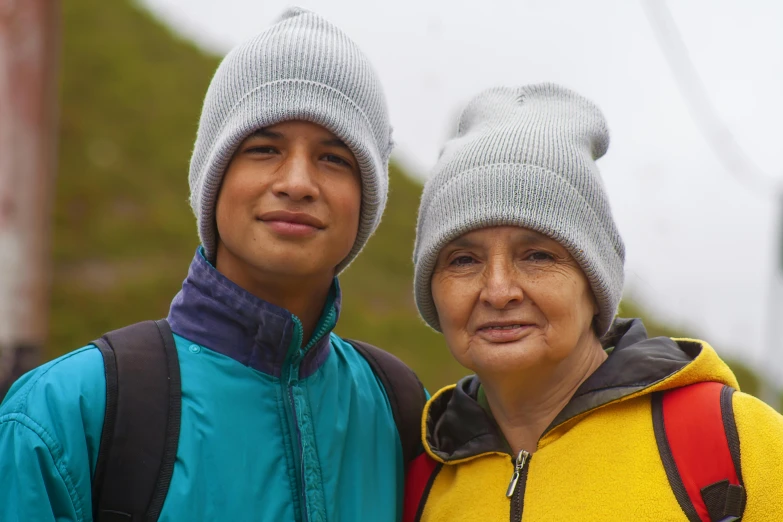 an elderly man and woman smiling next to each other