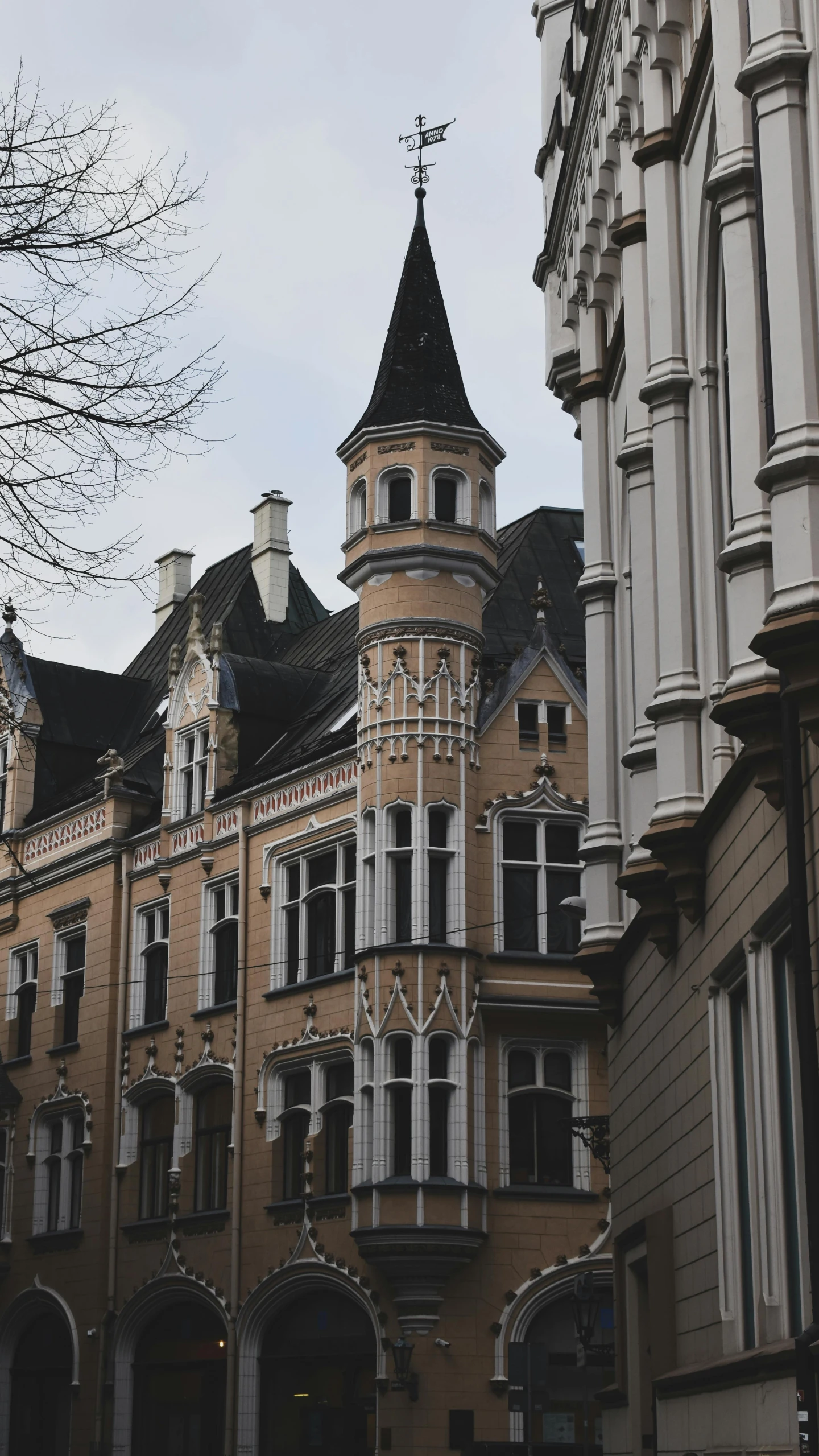 the building has many windows and a weather vein