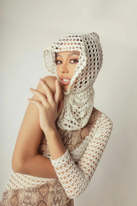 a young black woman wearing a lacy veil and scarf
