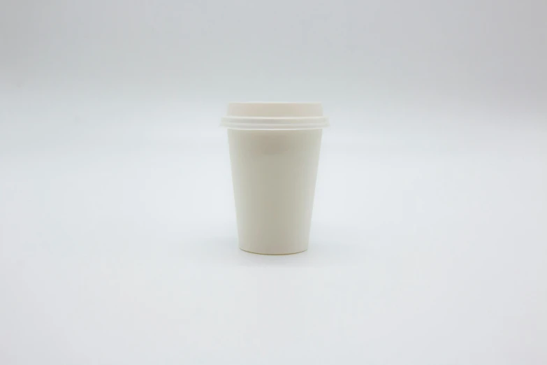 white coffee cup on table against white background