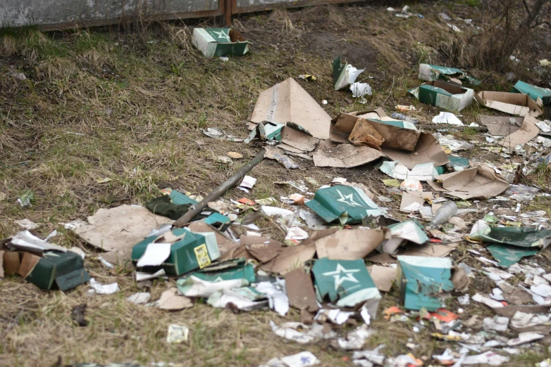 a pile of garbage next to some fence