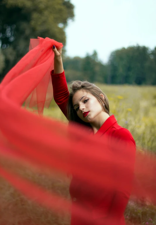 a woman in a red dress standing outdoors