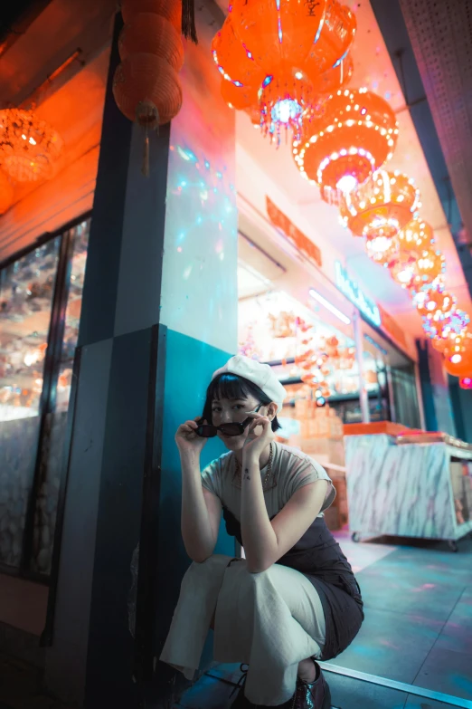 a girl sitting on the ground talking on her cell phone