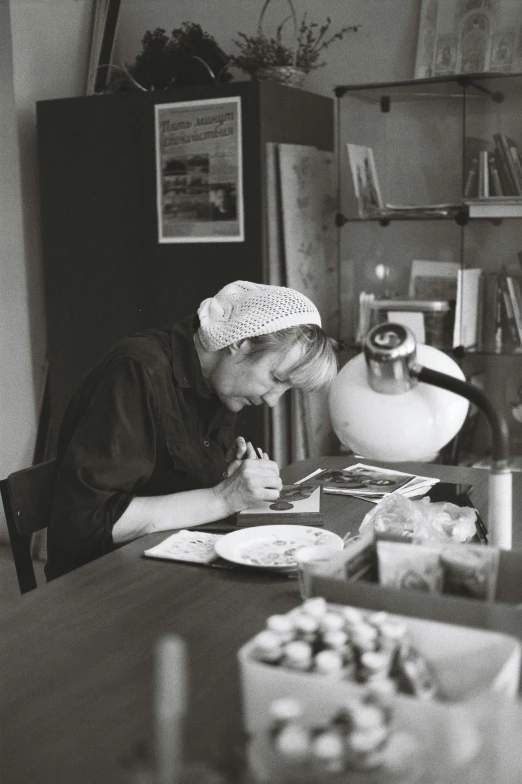 a lady wearing a kitchen cap is in her kitchen, eating and eating