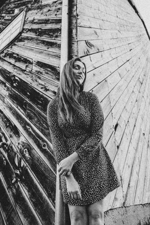 woman standing with her umbrella open next to a log building