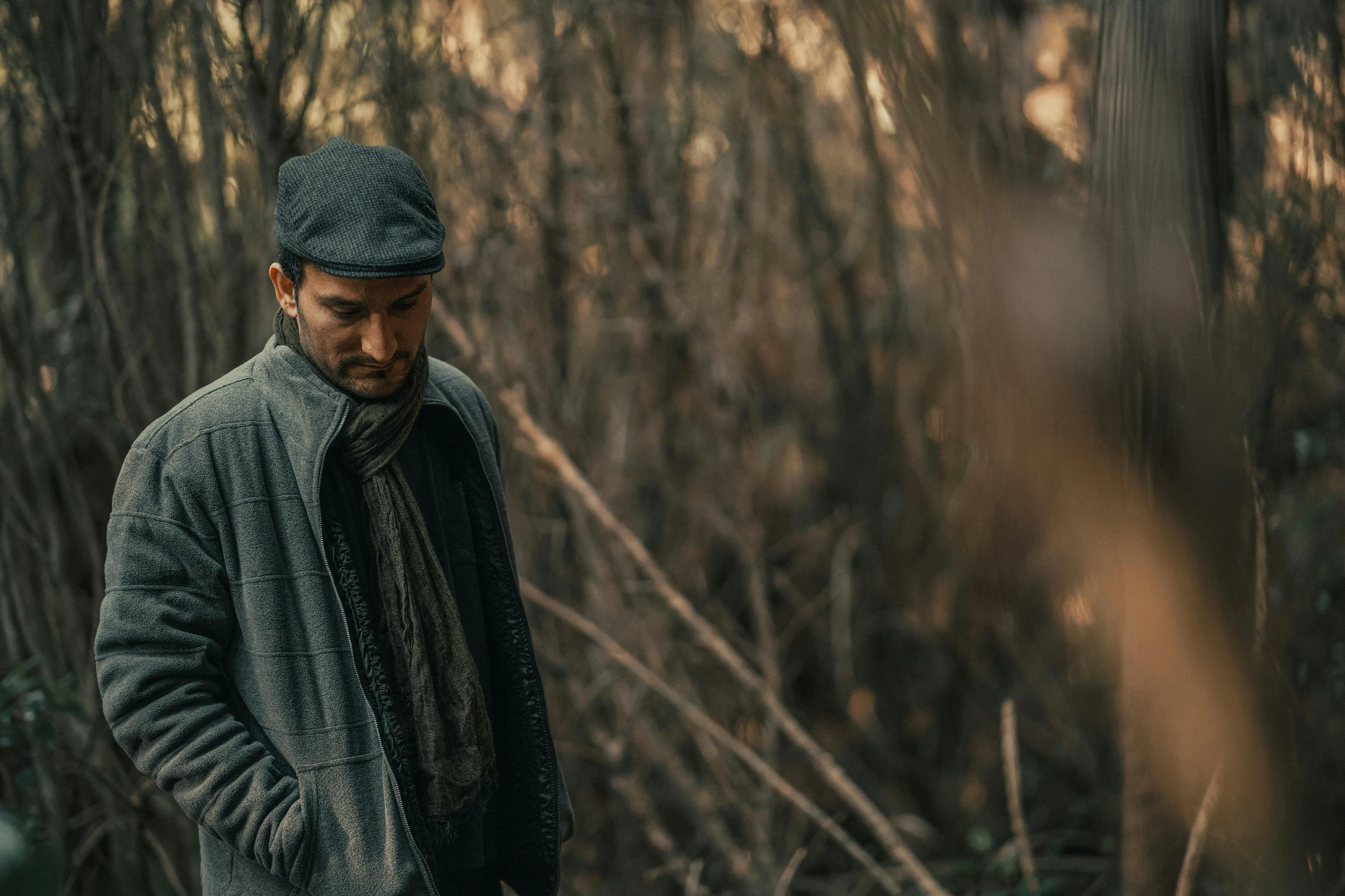 a man in the woods wearing a knit hat