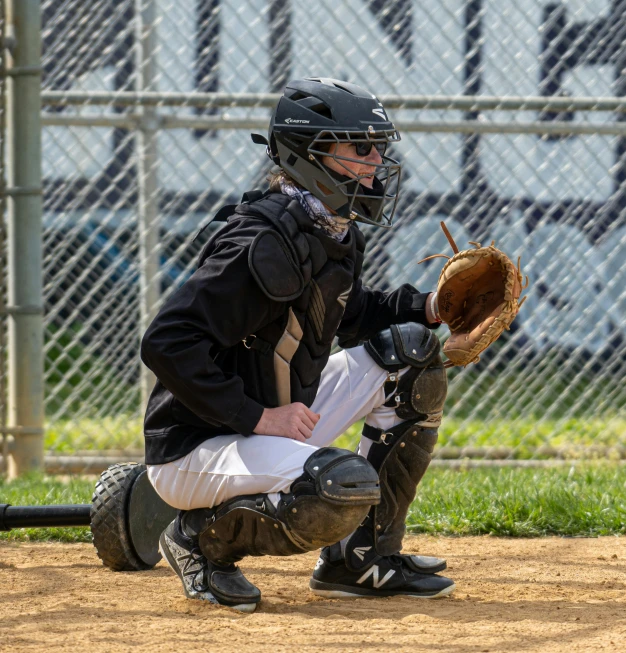 a person holding a catchers mitt on top of a baseball field