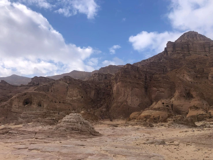 a dirt field is shown in front of a mountain