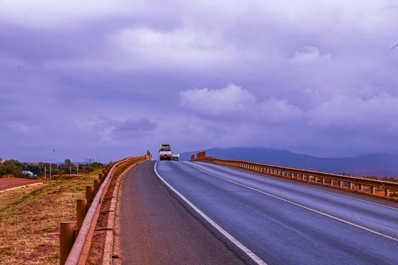 there are two lanes of highway going under the clouds