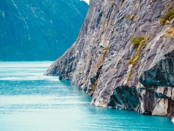 a large mountain with some water next to it