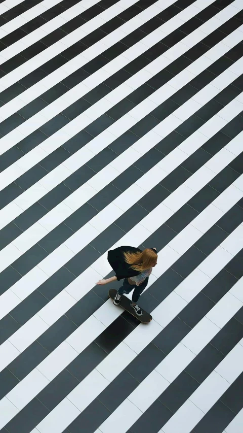 a skateboarder rides down the diagonal surface of a building