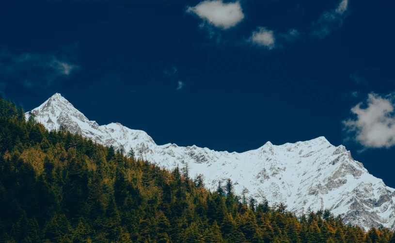 a mountain with snow is seen from below