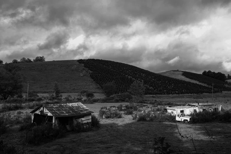 black and white po of storm clouds over the hill