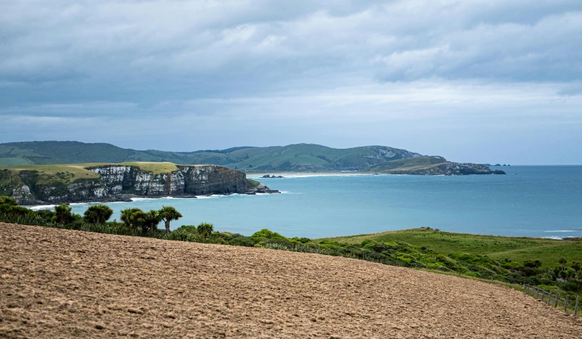 a view over an island and body of water from the top of a hill