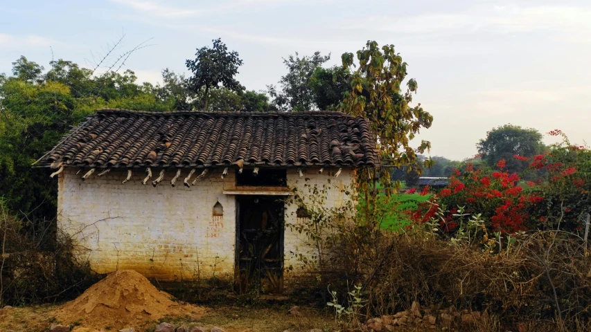 an old white building with a tiled roof