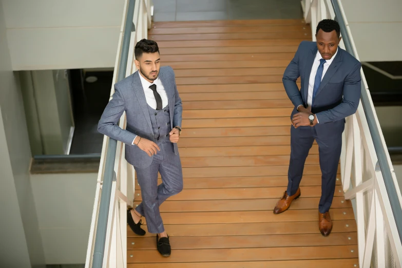 two men in suits stand on some stairs