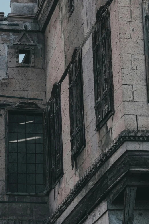 a building that has black wooden windows and a clock tower