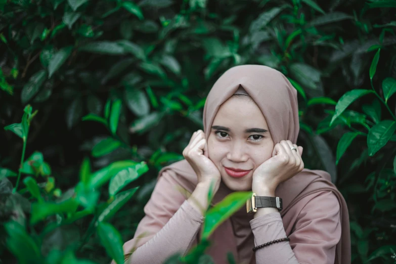 a woman in a hijab poses while posing for the camera