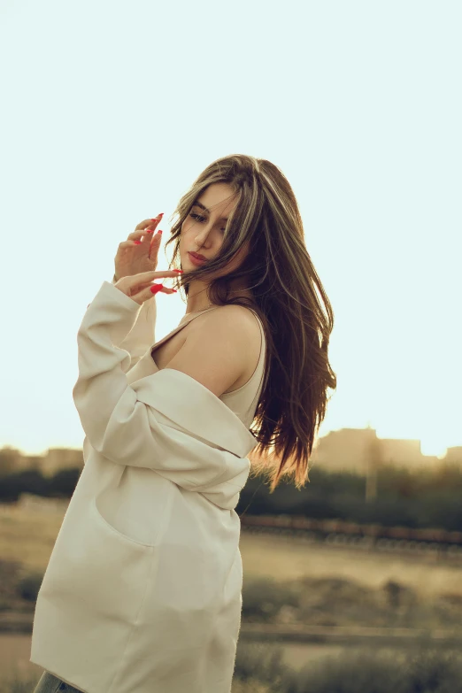 a beautiful woman in a white dress is outside