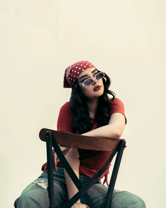 an adorable young lady sitting on top of a chair