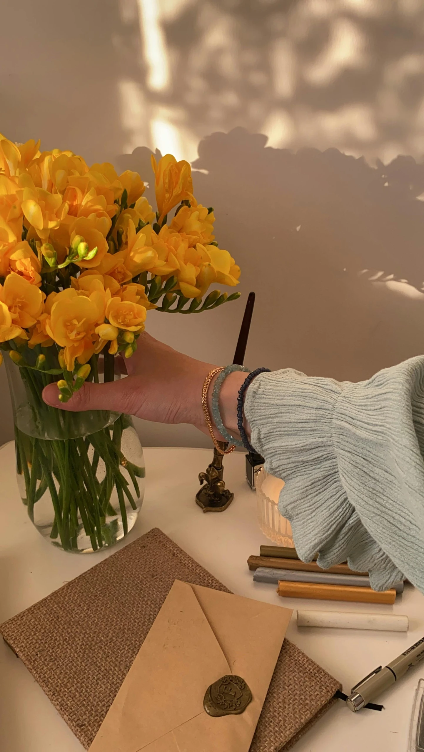 a woman holding a bunch of flowers on her arm