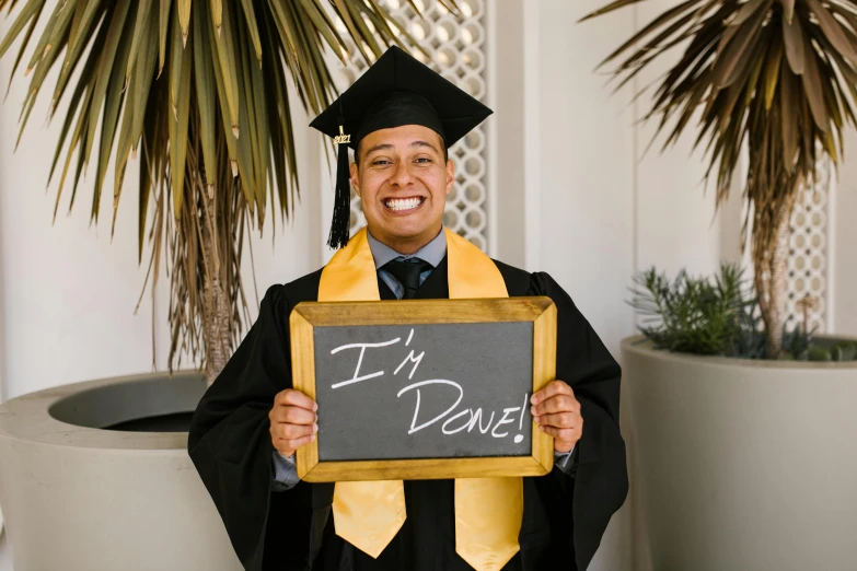 a man holds up a chalk board saying i'd dance