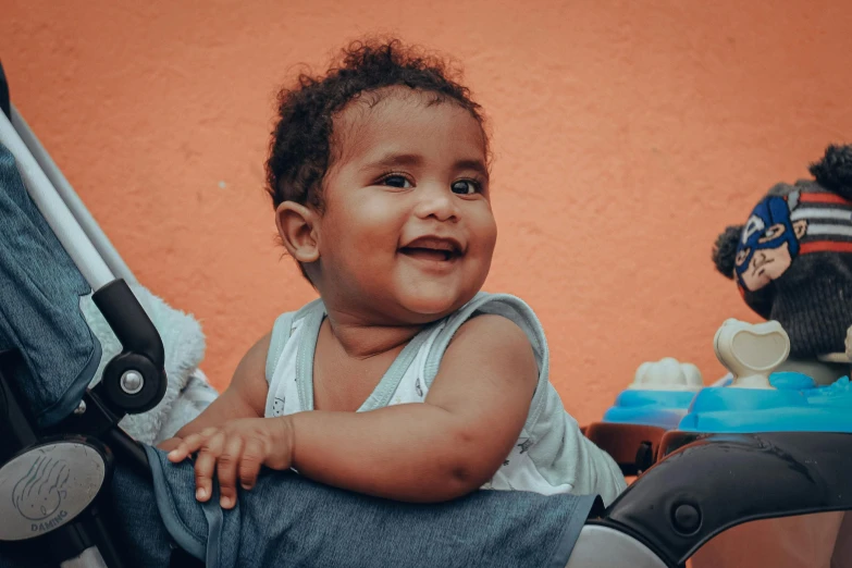 a small child is in a high chair and smiles