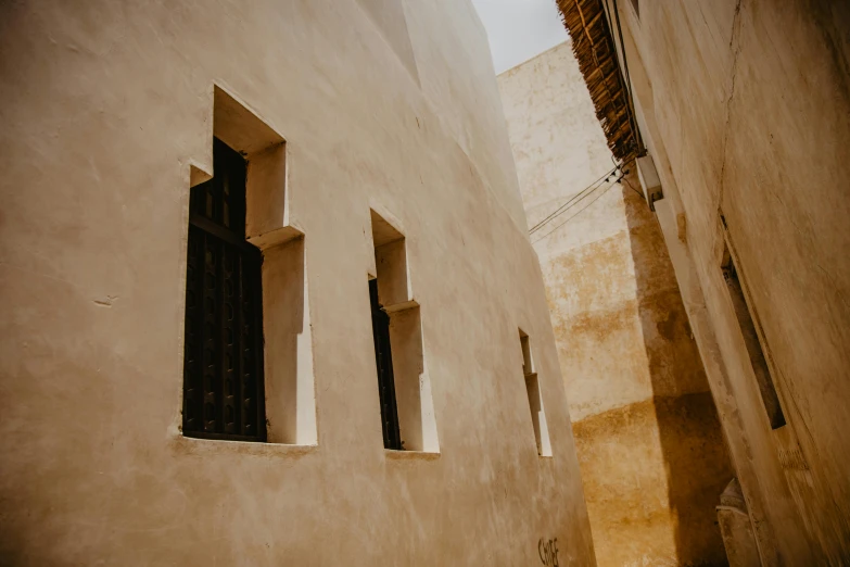 a couple of windows that are on the side of a building