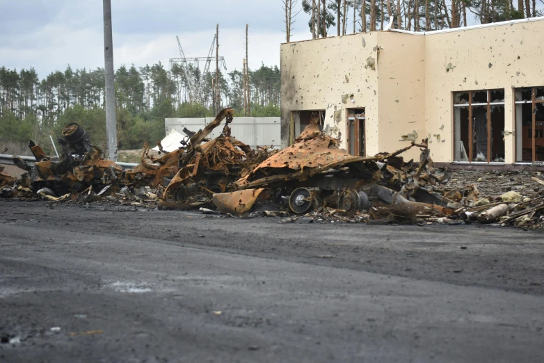 a damaged and destroyed building with a bunch of debris on the ground