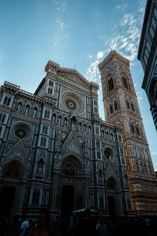 cathedral, two towers, large blue sky with clouds in background