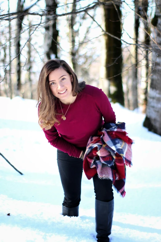 a woman in black pants is posing in the snow