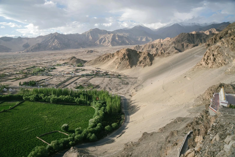 the beautiful green valley has many mountains in the background