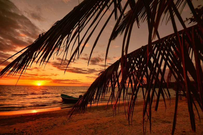 a sailboat sitting on top of a sandy beach