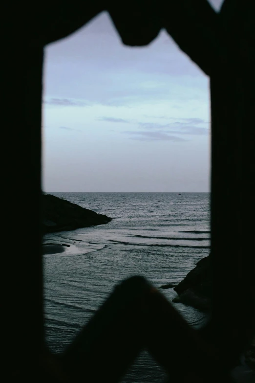 a view of the ocean from a window in a cabin