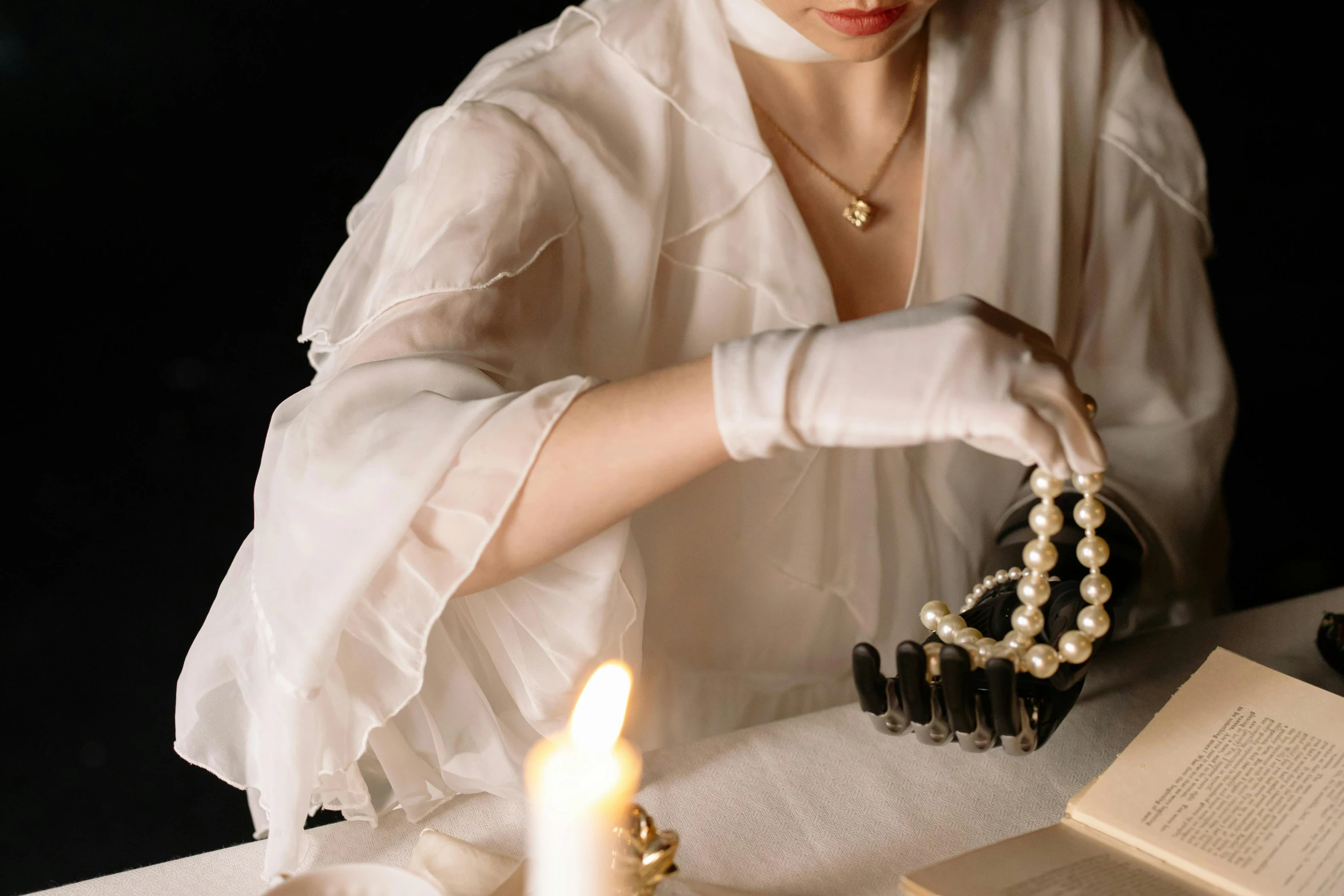 a person is putting pearls on a book