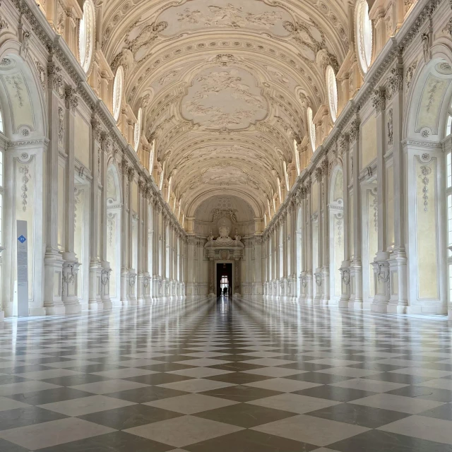 a large hallway with arches and floor tile