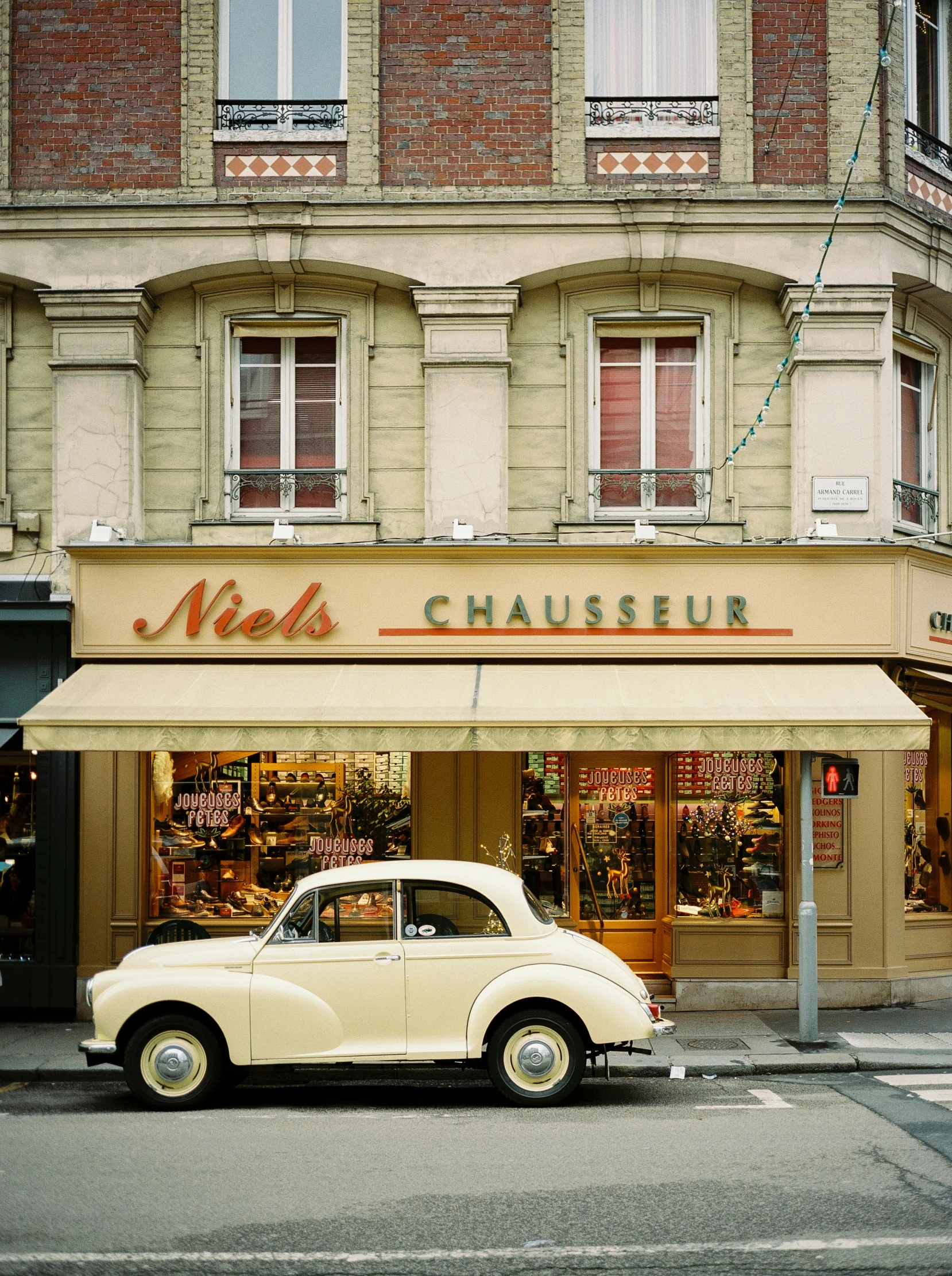 an old car is parked on the street by a restaurant