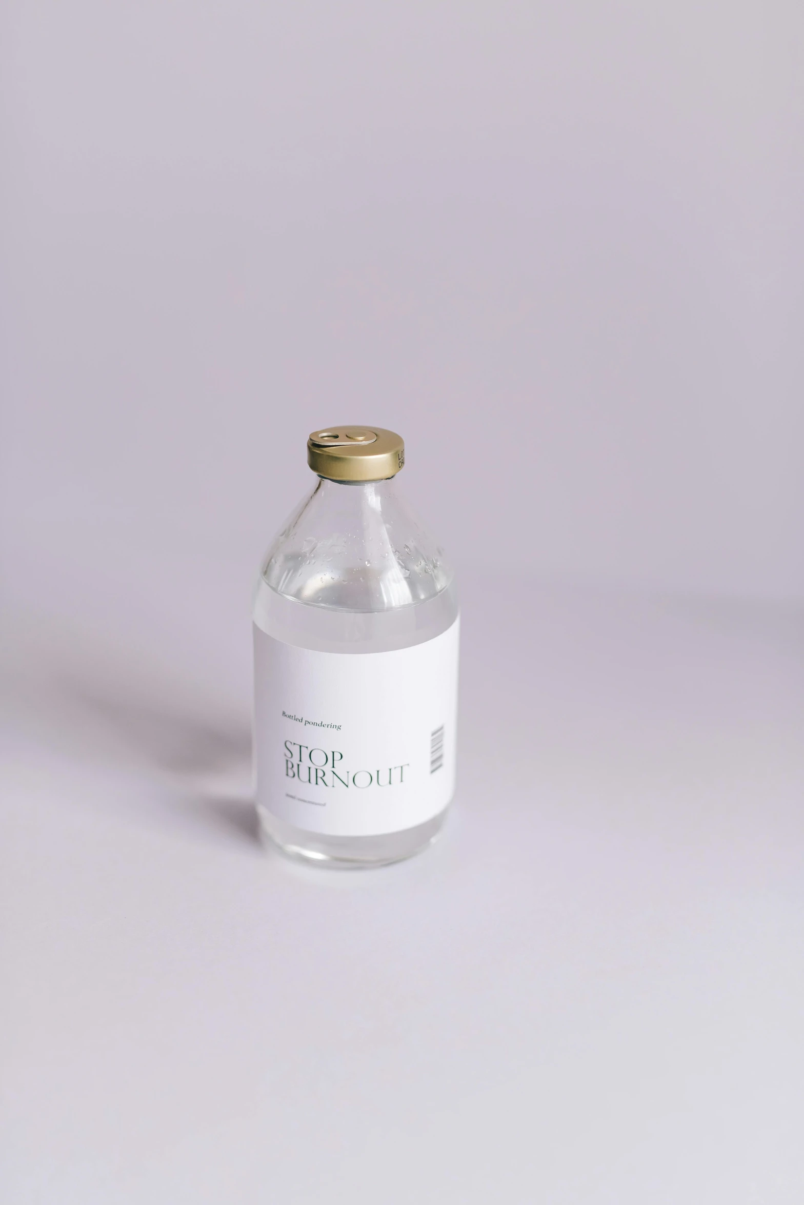 a bottle sitting up against a white background