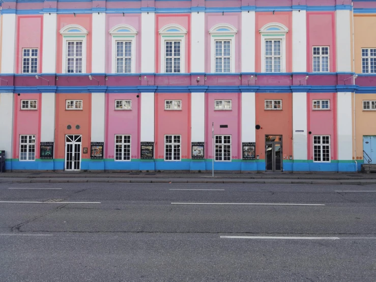 a large multicolored building on the street