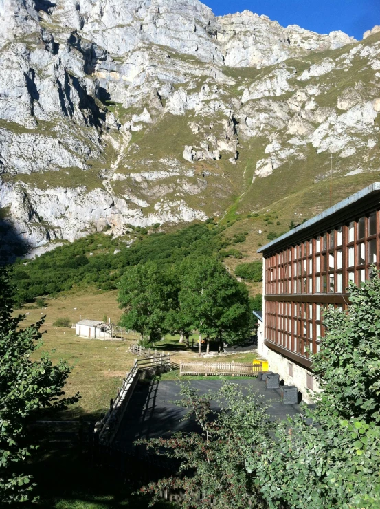 a building with a large window and a mountain in the background