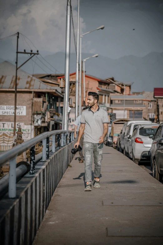 a man that is walking down a sidewalk