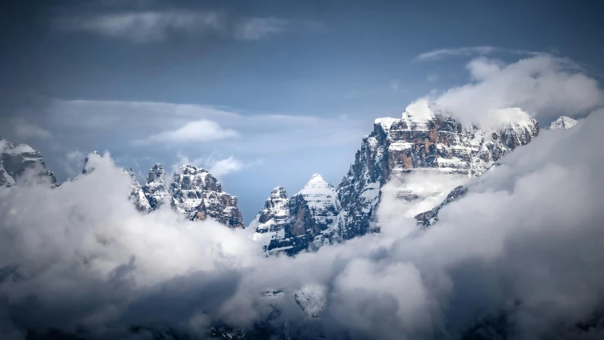 a scenic view of a mountain range with a cloud formation