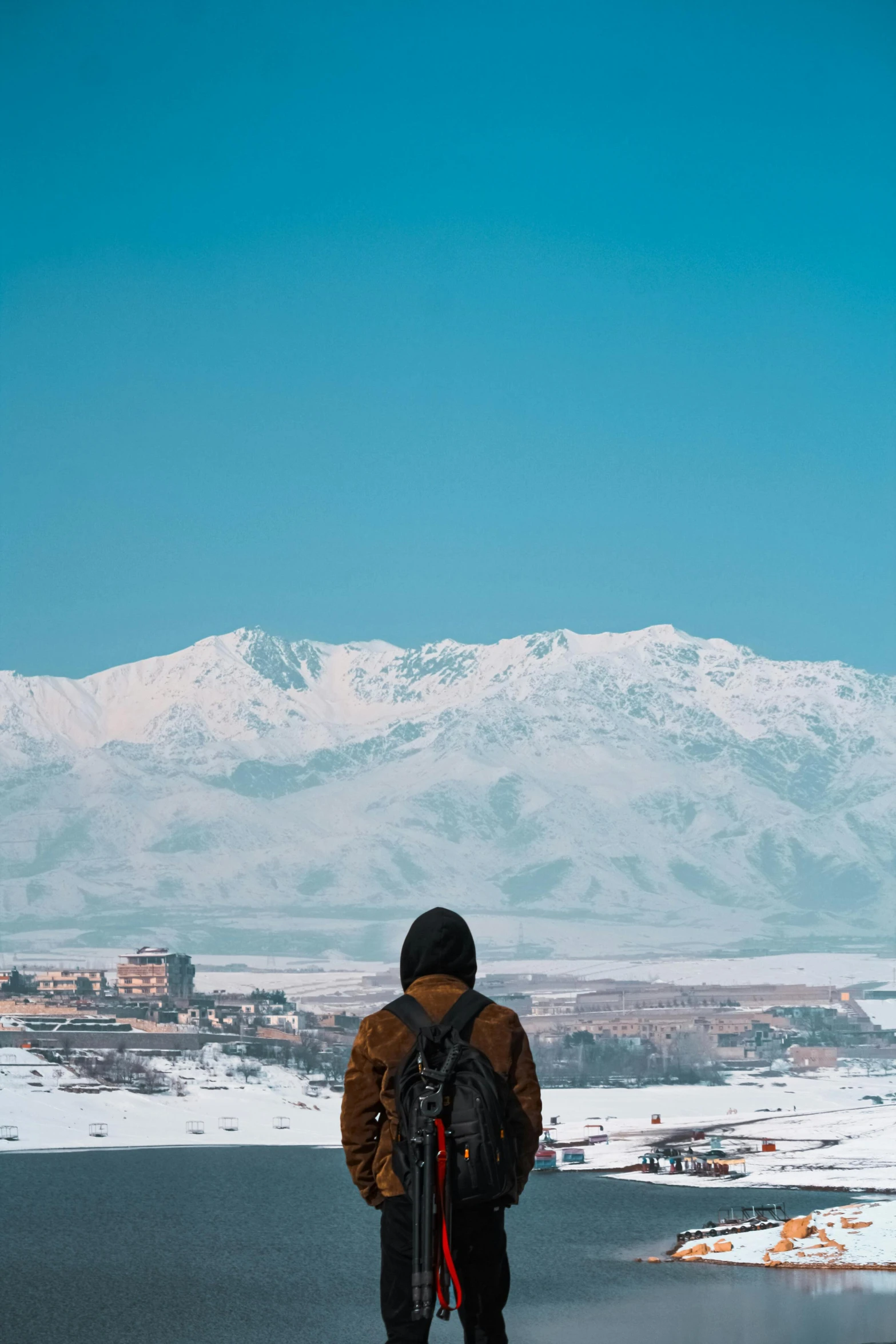 a man is looking at a mountain top in the distance