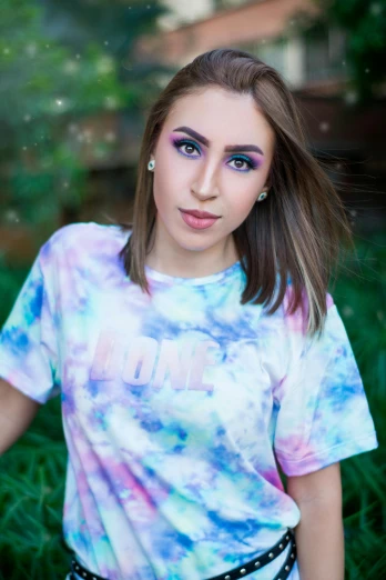 posing on grass, with tie dyed blue eyes